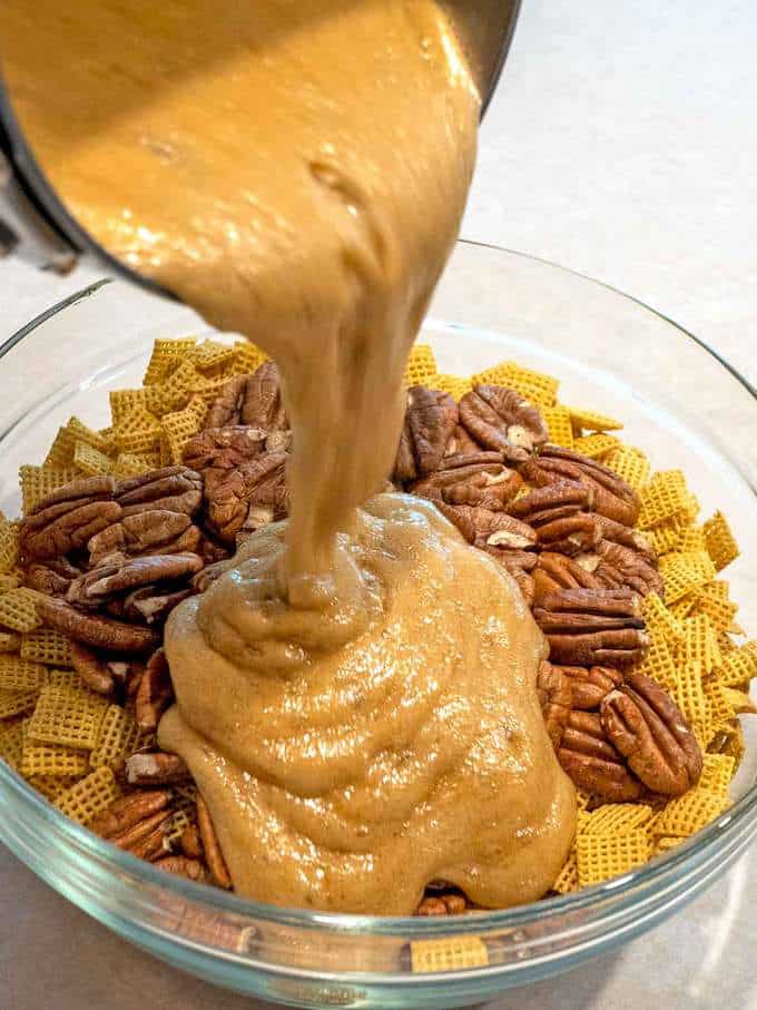 Pouring Caramel over Corn Chex and Pecans