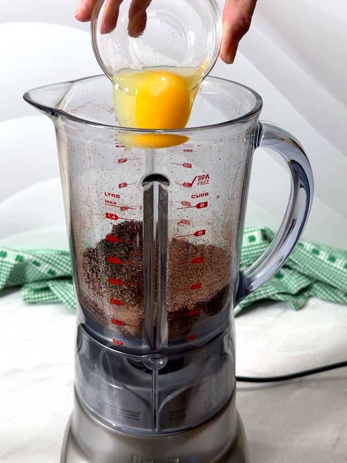 Adding the egg to the blender.