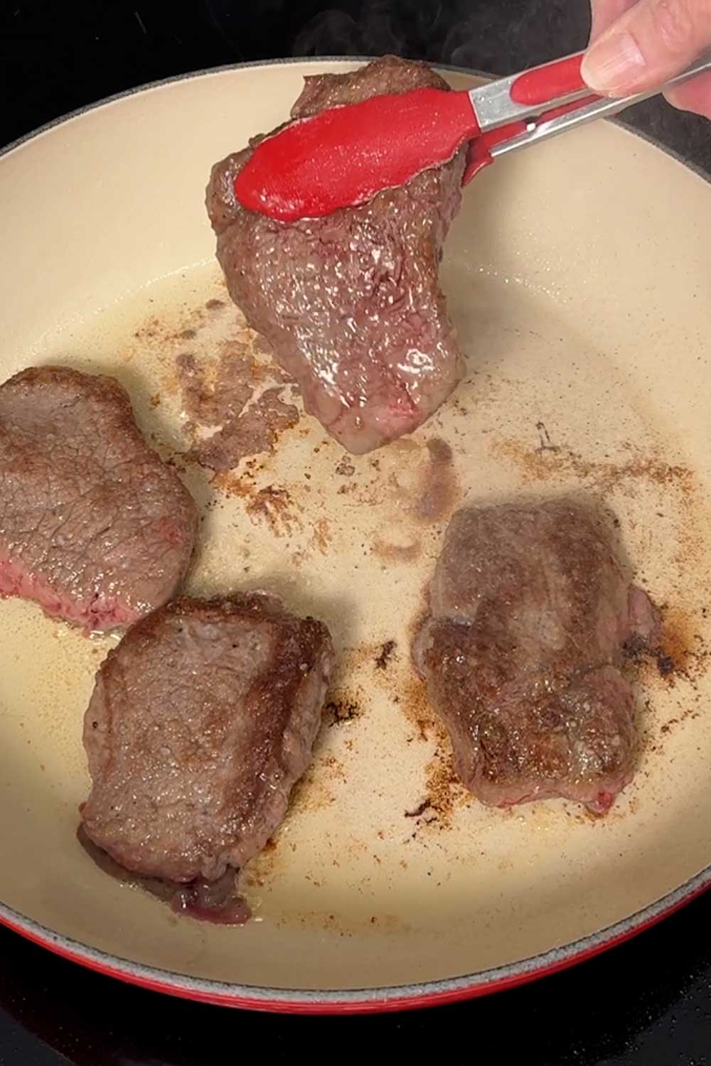 Browning the beef in the Dutch oven.