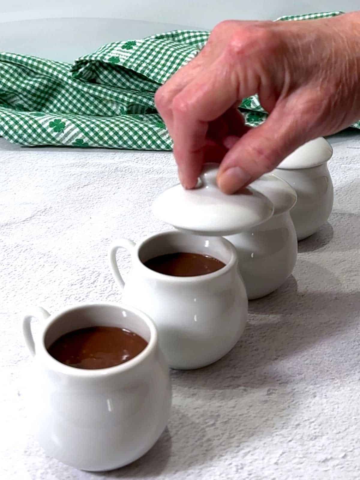 Covering the porcelain cups with the lids.