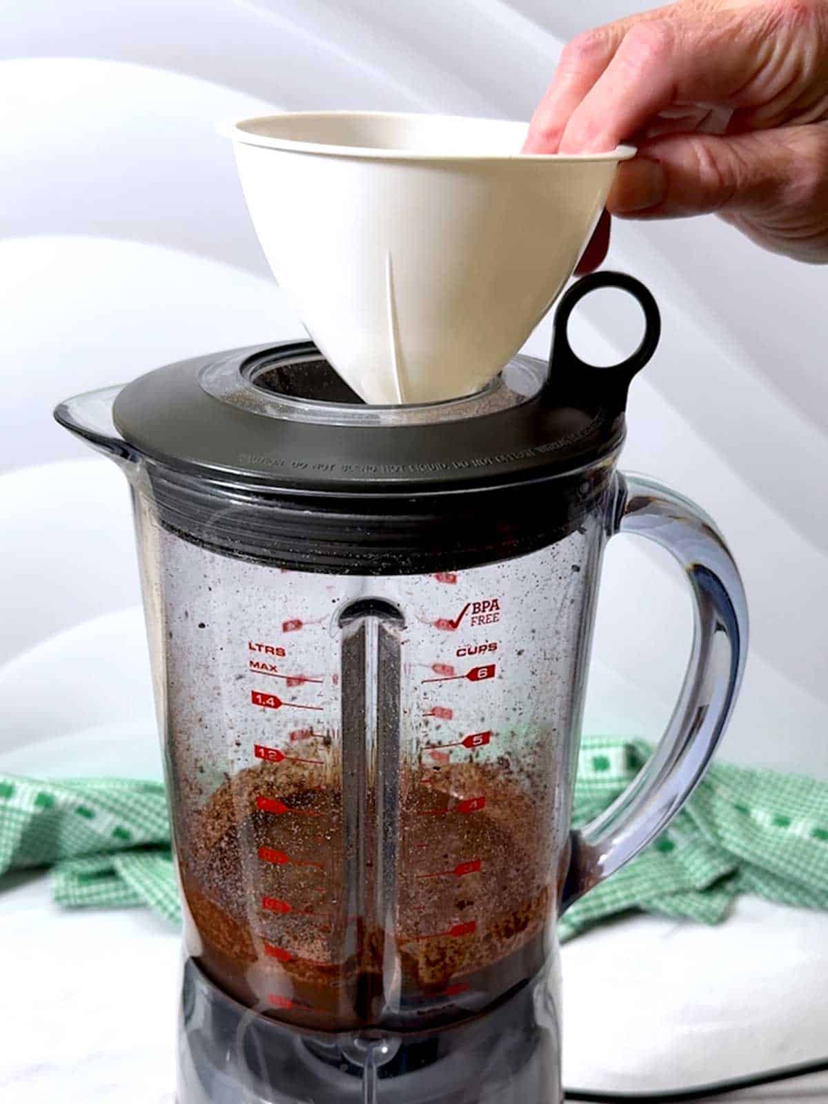 Placing funnel in the blender.