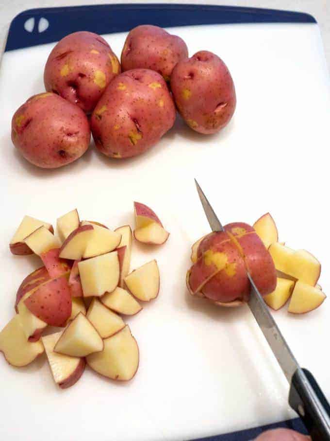 Cutting the red potatoes into pieces