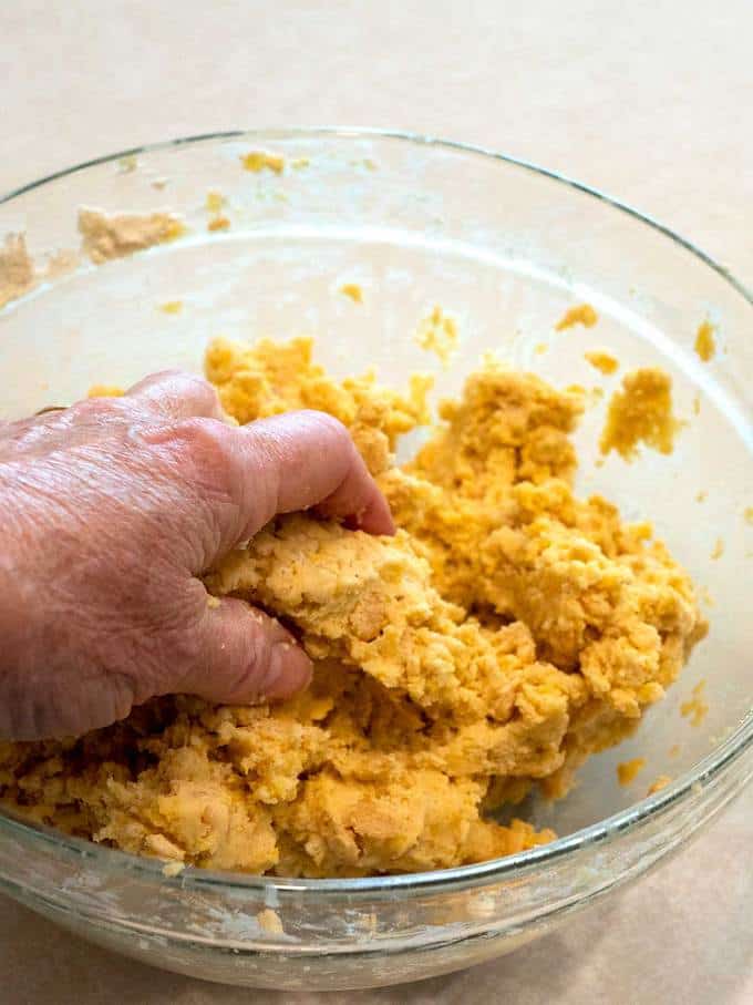 Using hands to incorporate the Rice Krispies into the dough