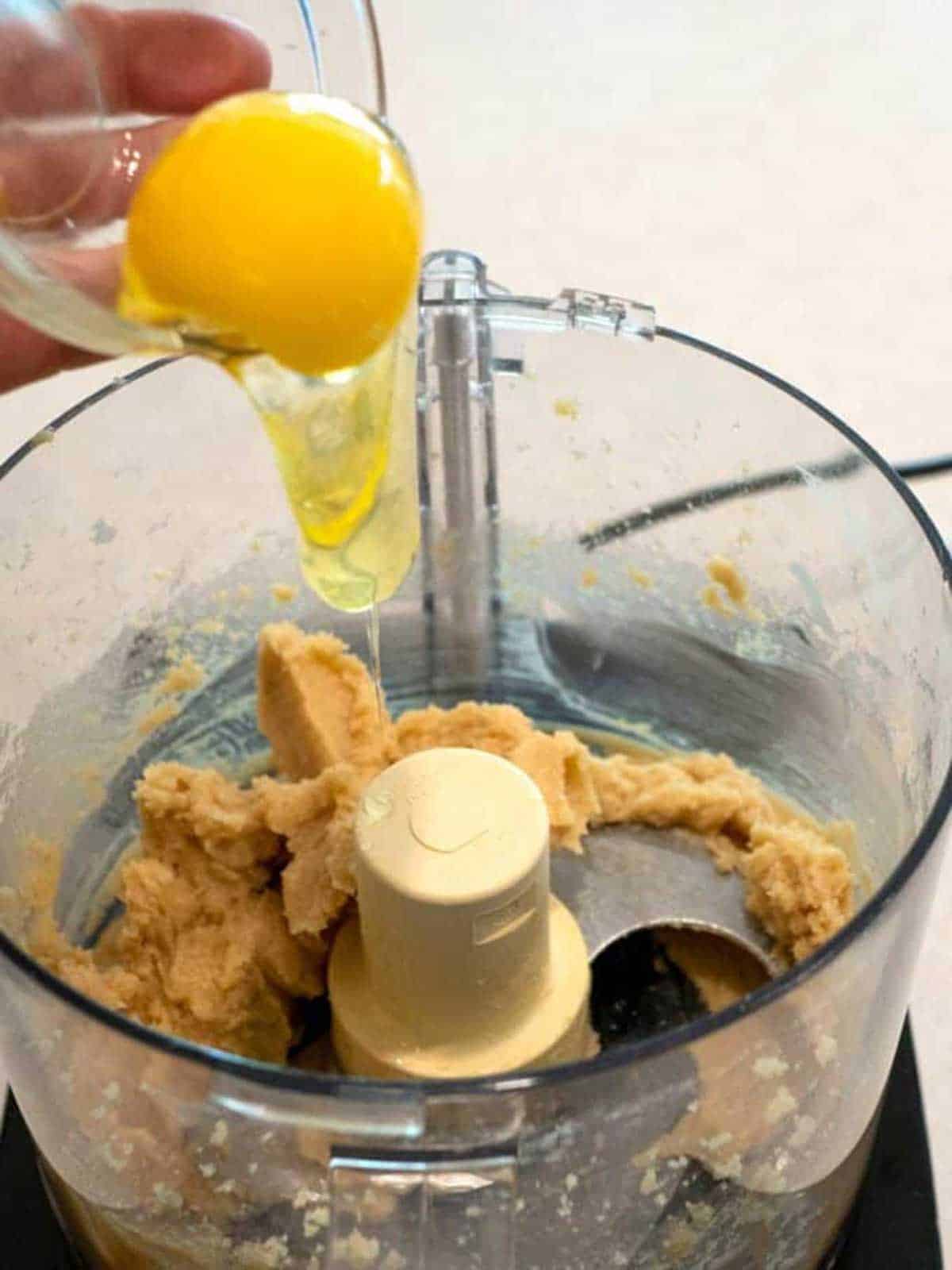 Adding the egg to the food processor.