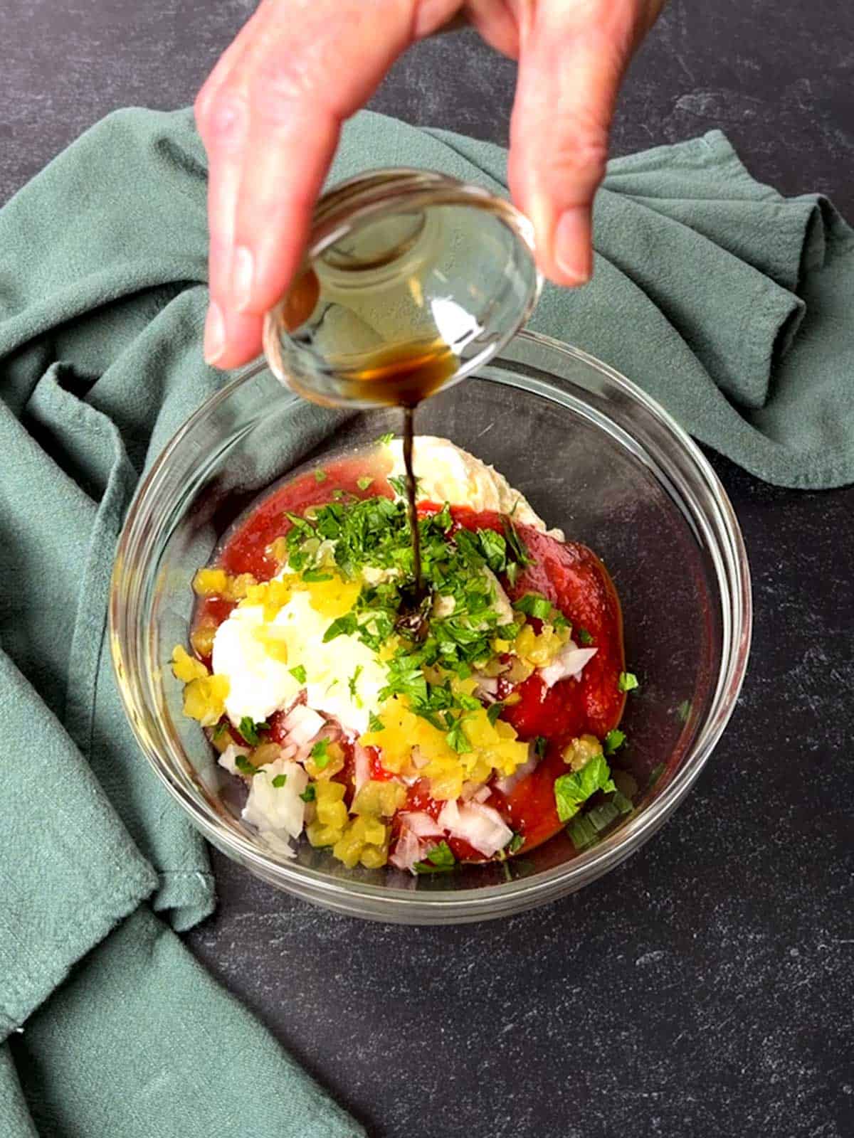 Adding Worcestershire sauce to the remaining ingredients.