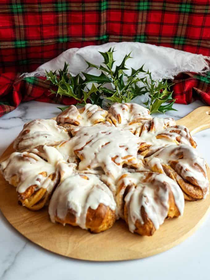 Cinnamon Snowflake Bread with powdered sugar dusting on a cooling rack