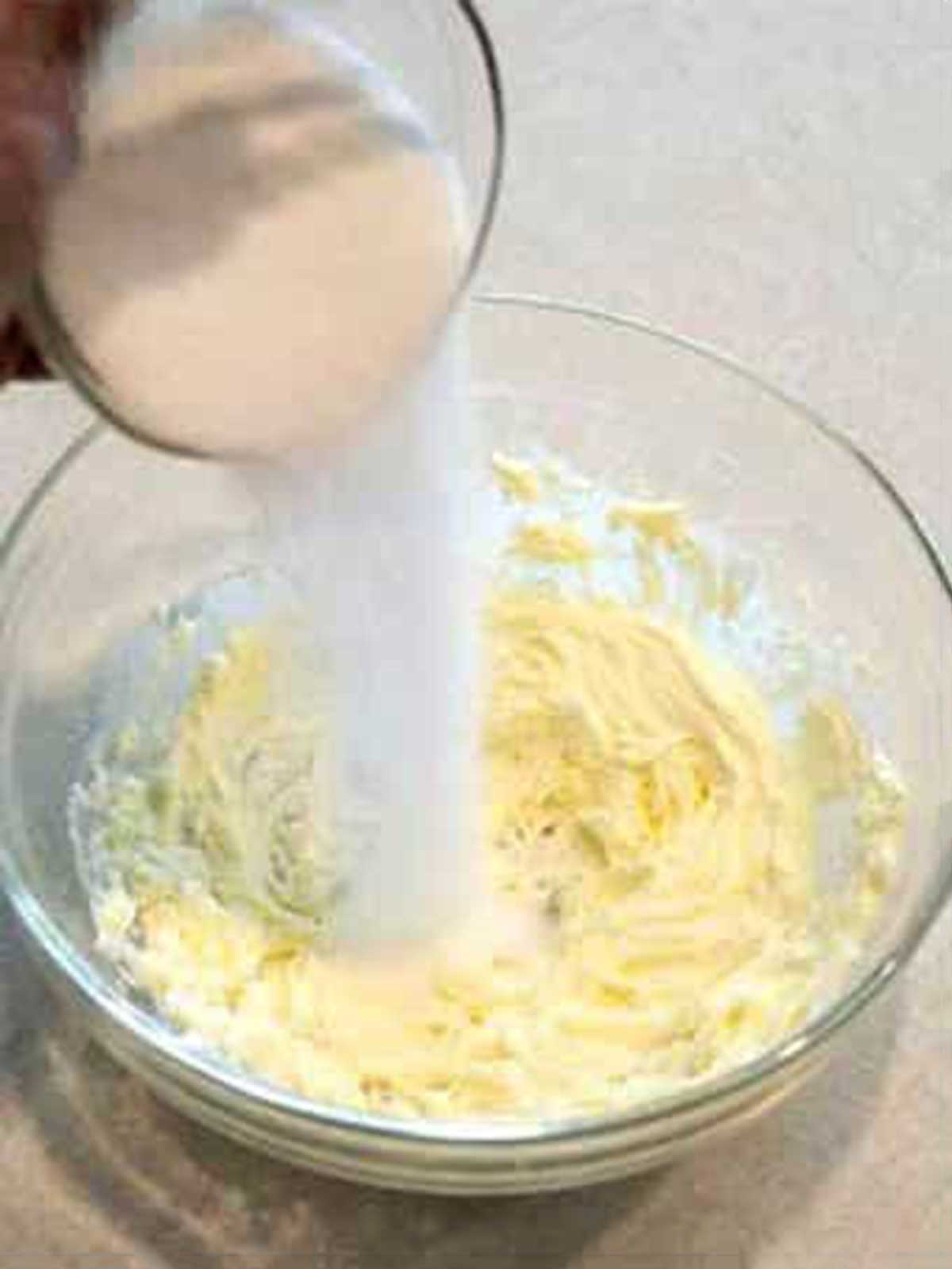 Adding sugar to creamed butter.