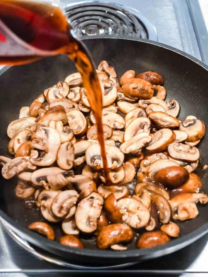 Adding Marsala to the mushrooms in the skillet