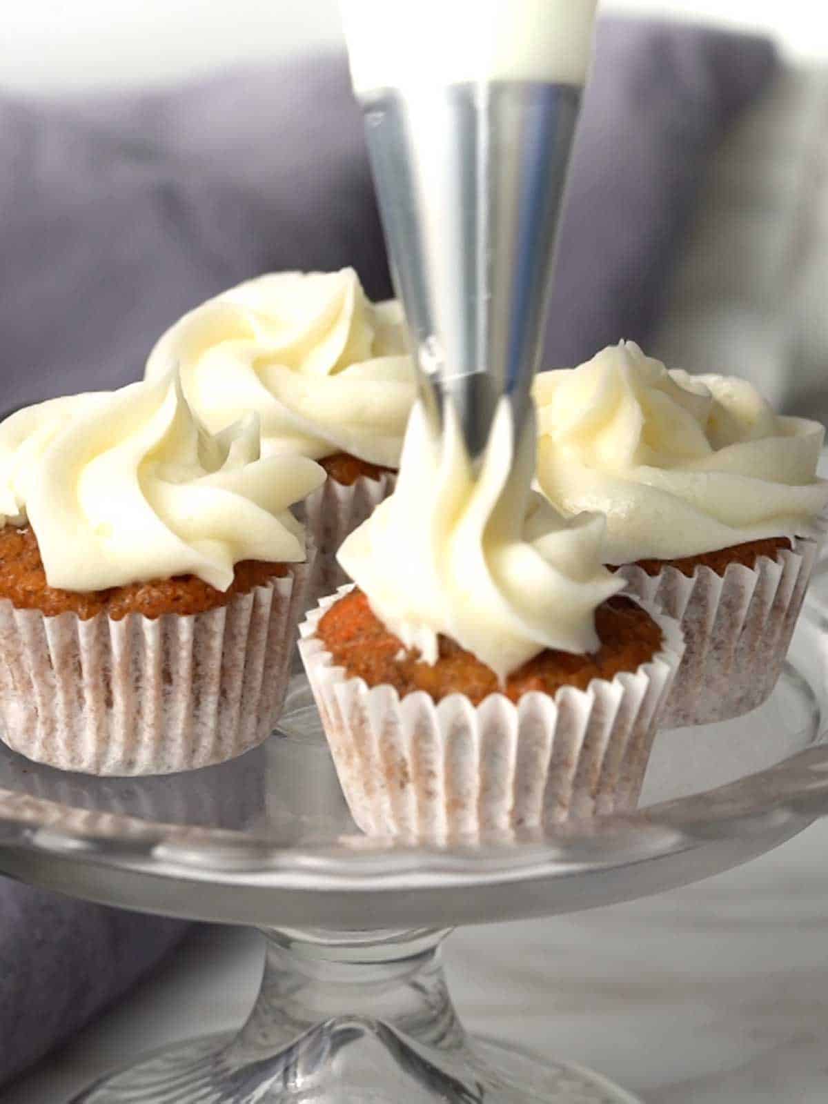Frosting the mini-carrot cupcakes