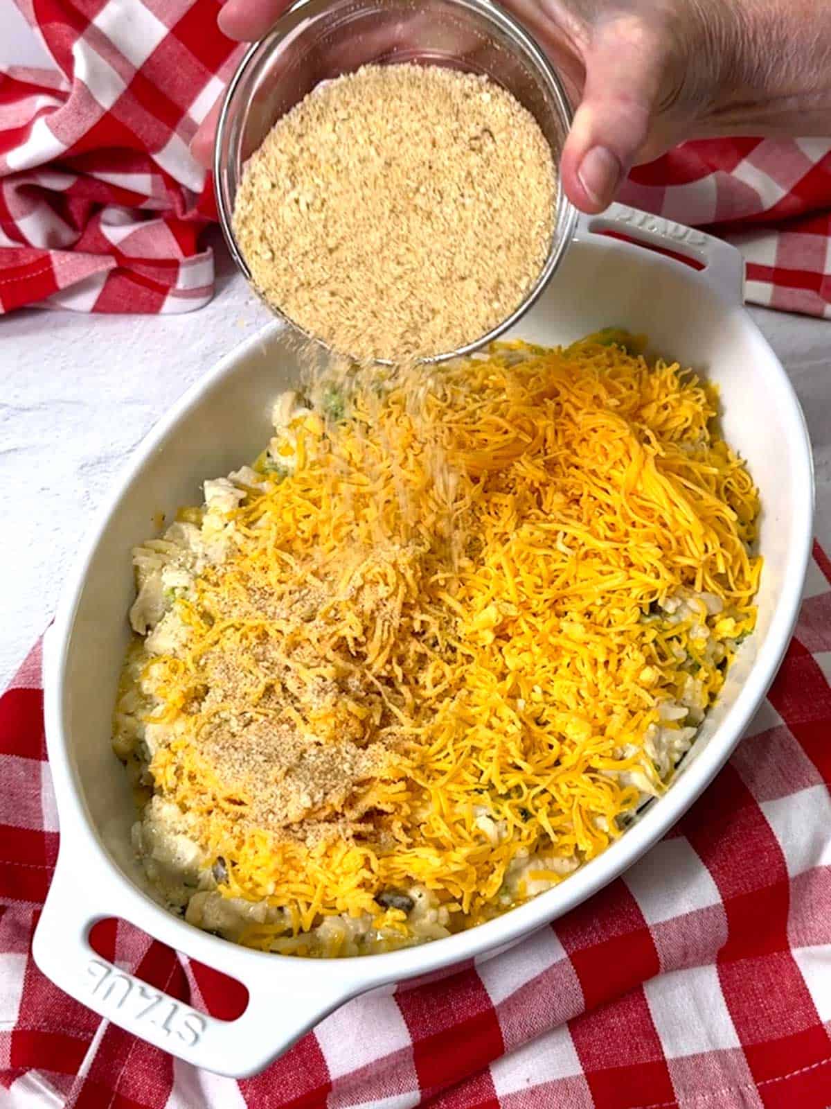 Adding breadcrumbs to the casserole.