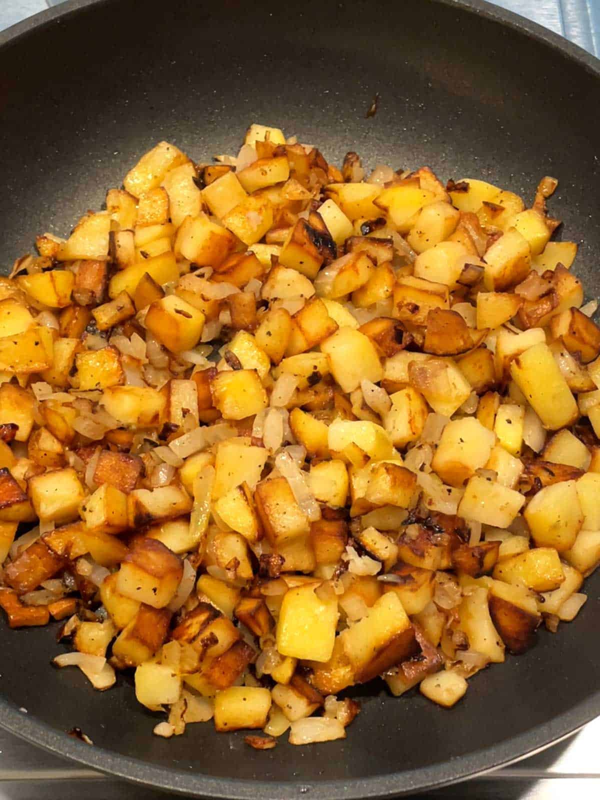 Potatoes and Onions cooked together in skillet.