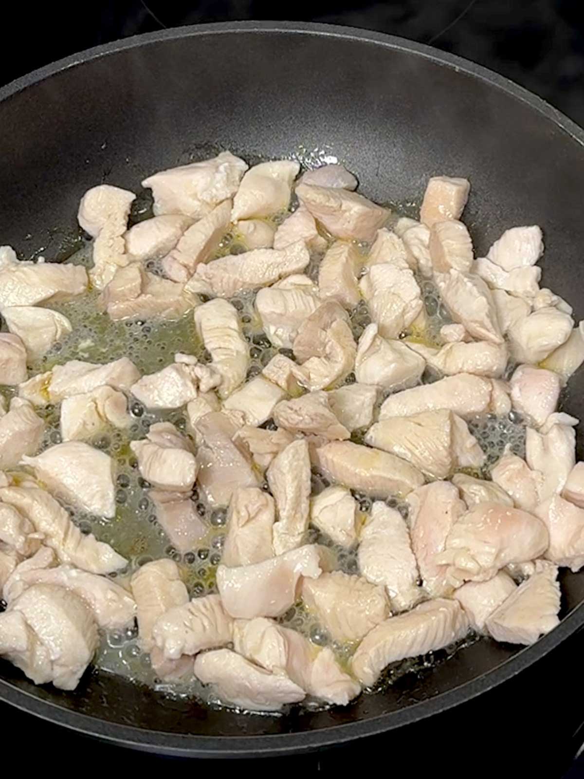 Cooked chicken in a skillet.