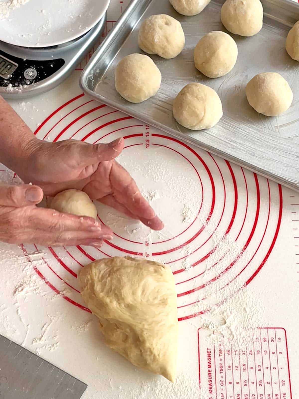 Forming the dough into balls on a floured surface.