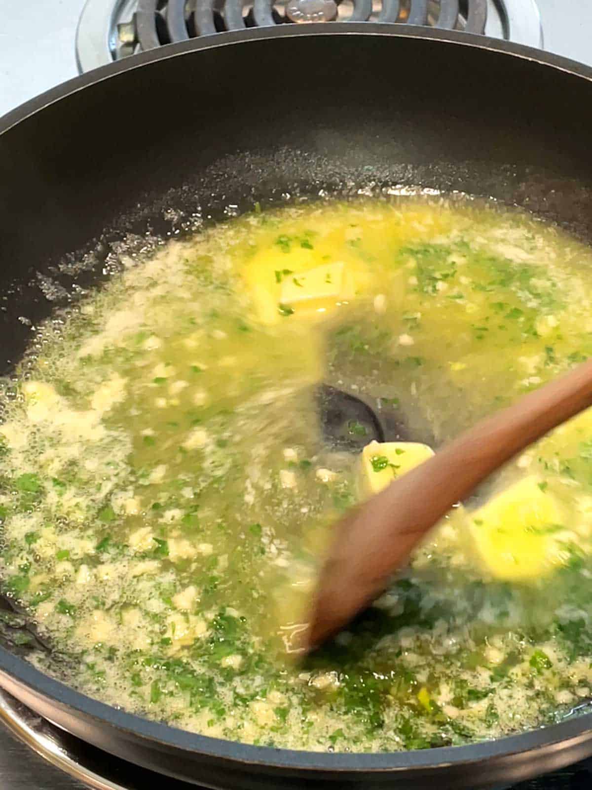 Melting butter with parsley and garlic.