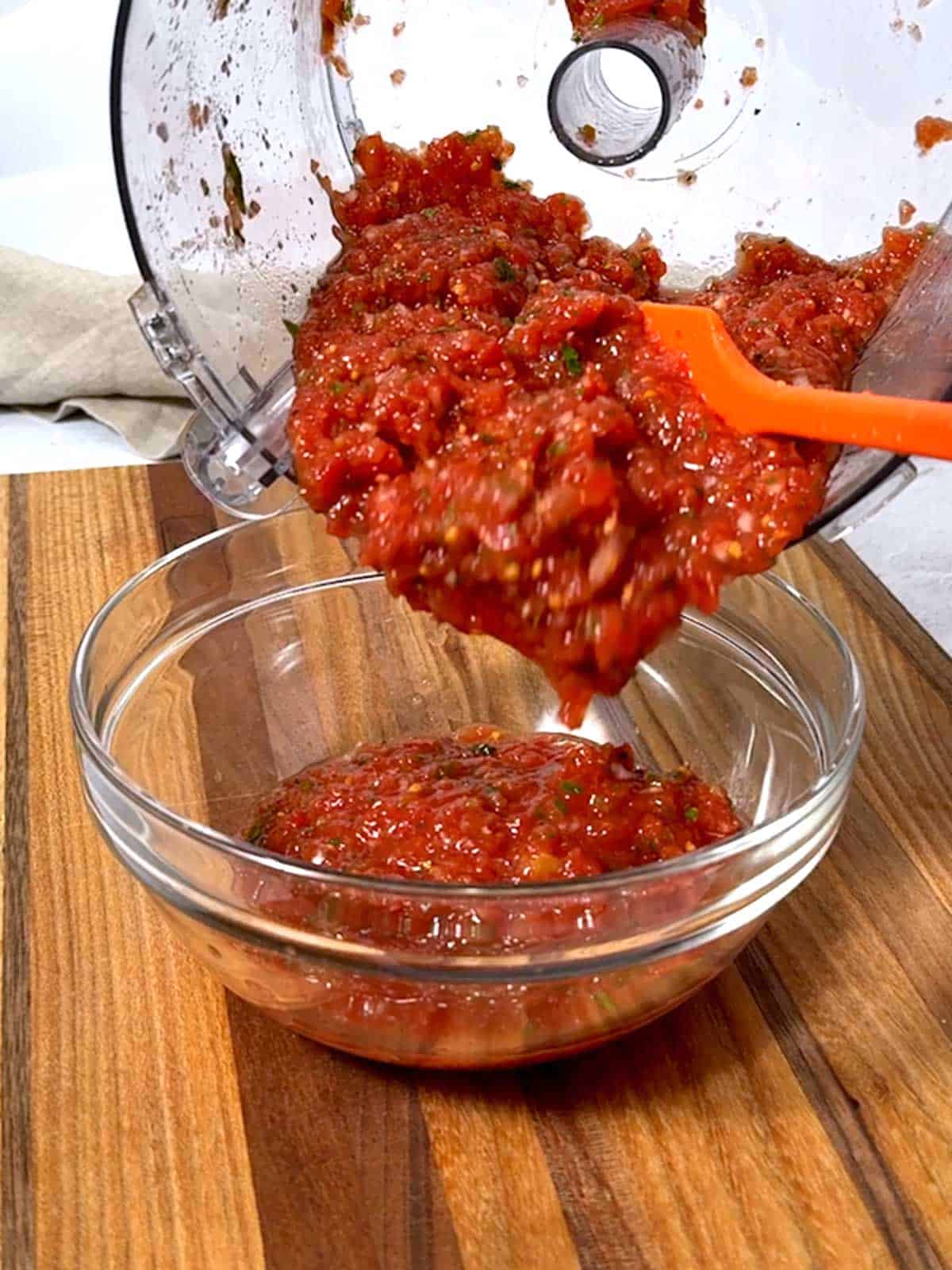 Transferring the salsa to a bowl.