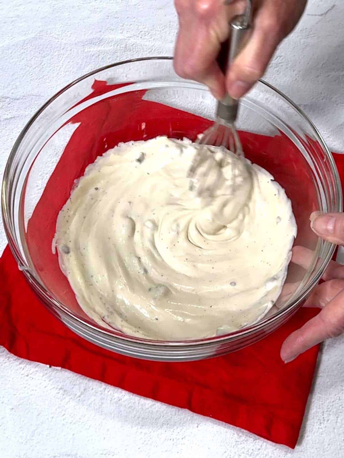 Whisking cream of mushroom soup and mayonnaise.