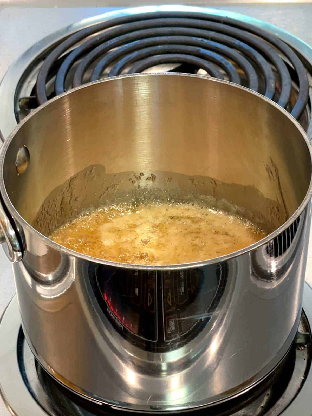 Caramel boiling in saucepan.