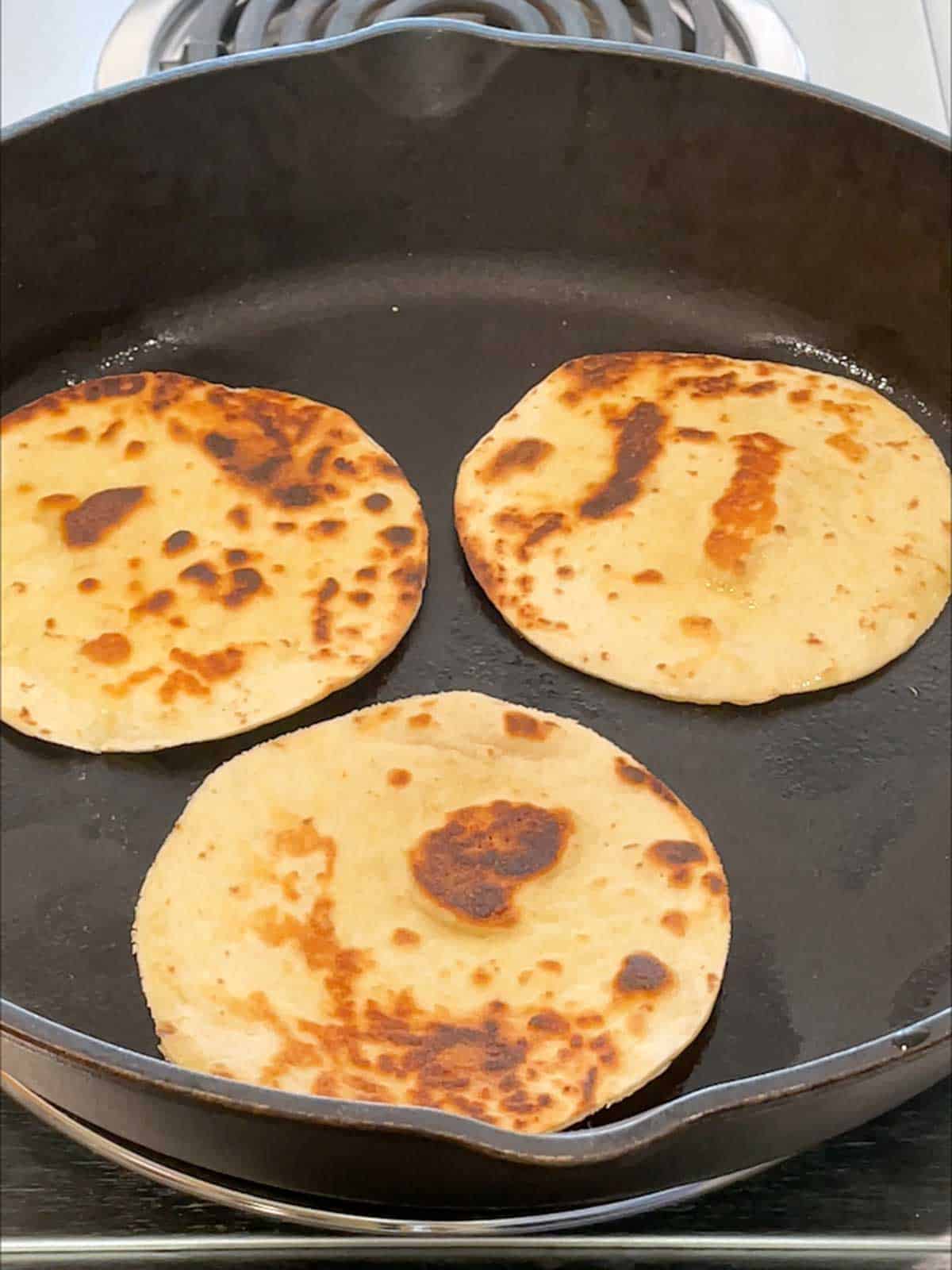 Browning tortilla circles in skillet.