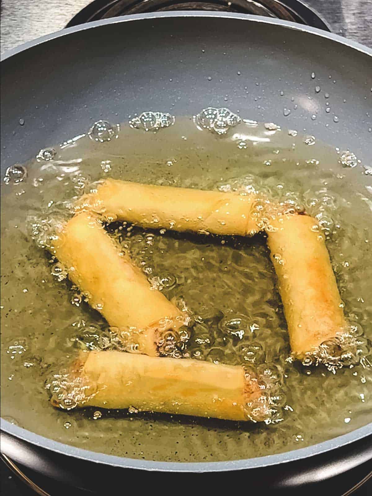 Frying the spring rolls in Wok