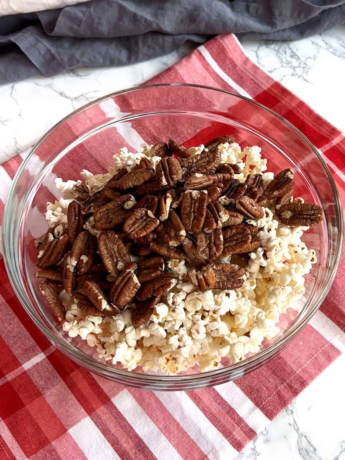 Popcorn and pecans in a large bowl.