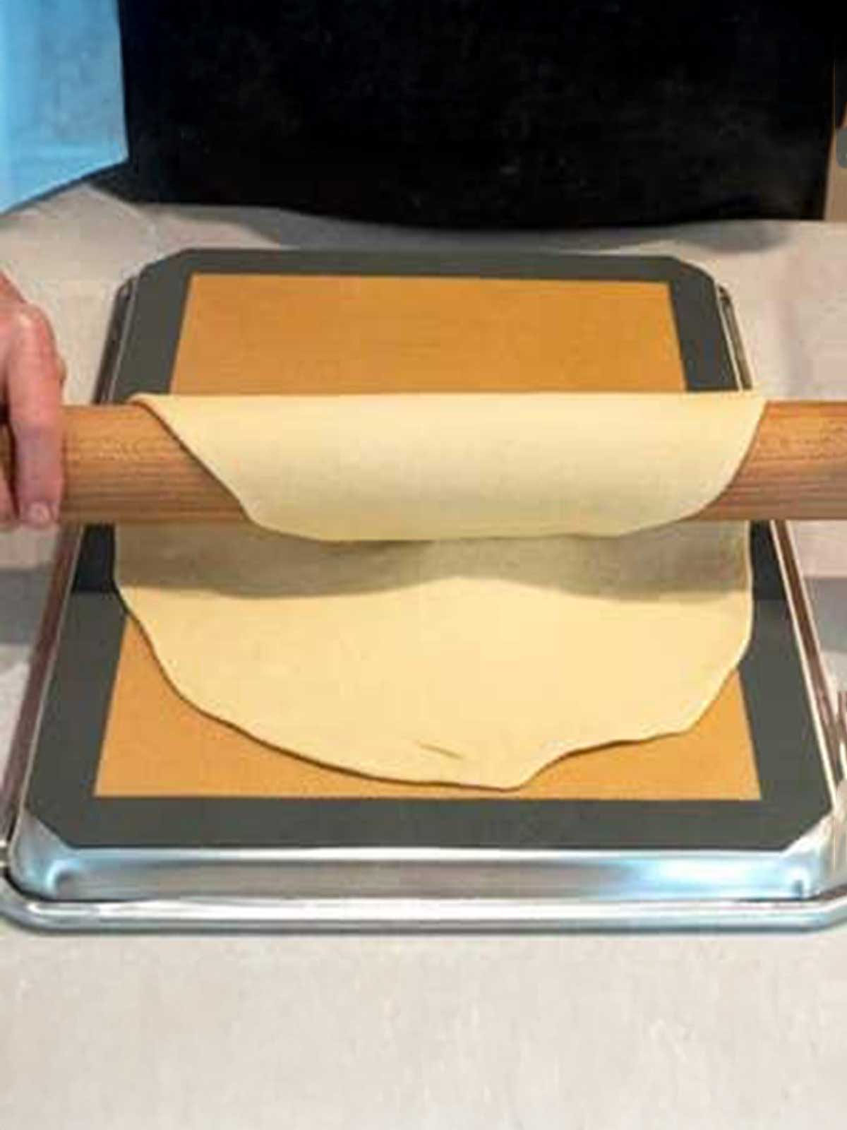 Placing first circle on an inverted half-sheet baking pan lined with silicone.