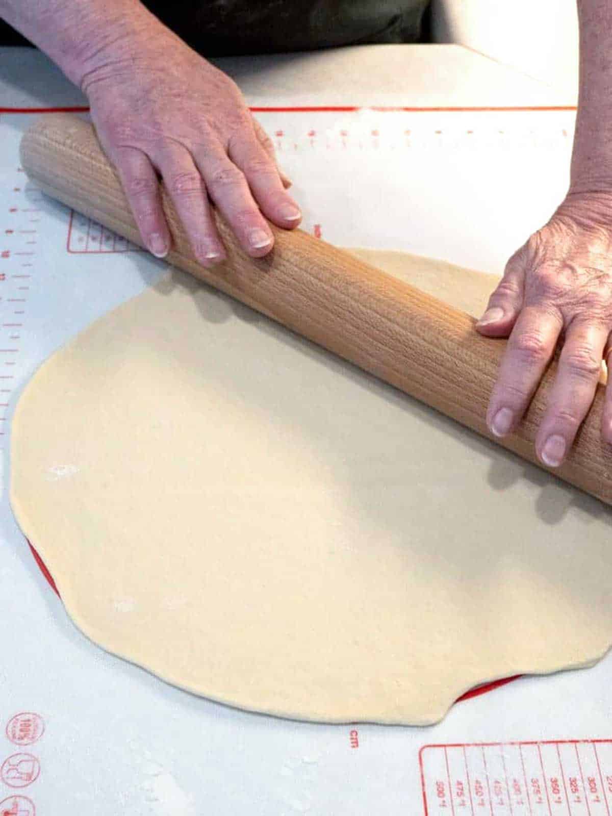 Rolling the dough into a circle.