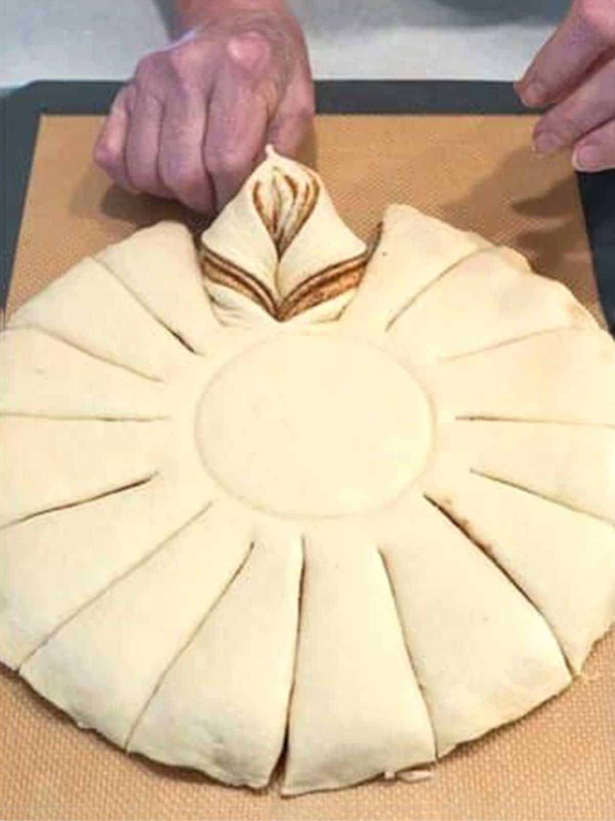 Pinching seams of twisted dough together.