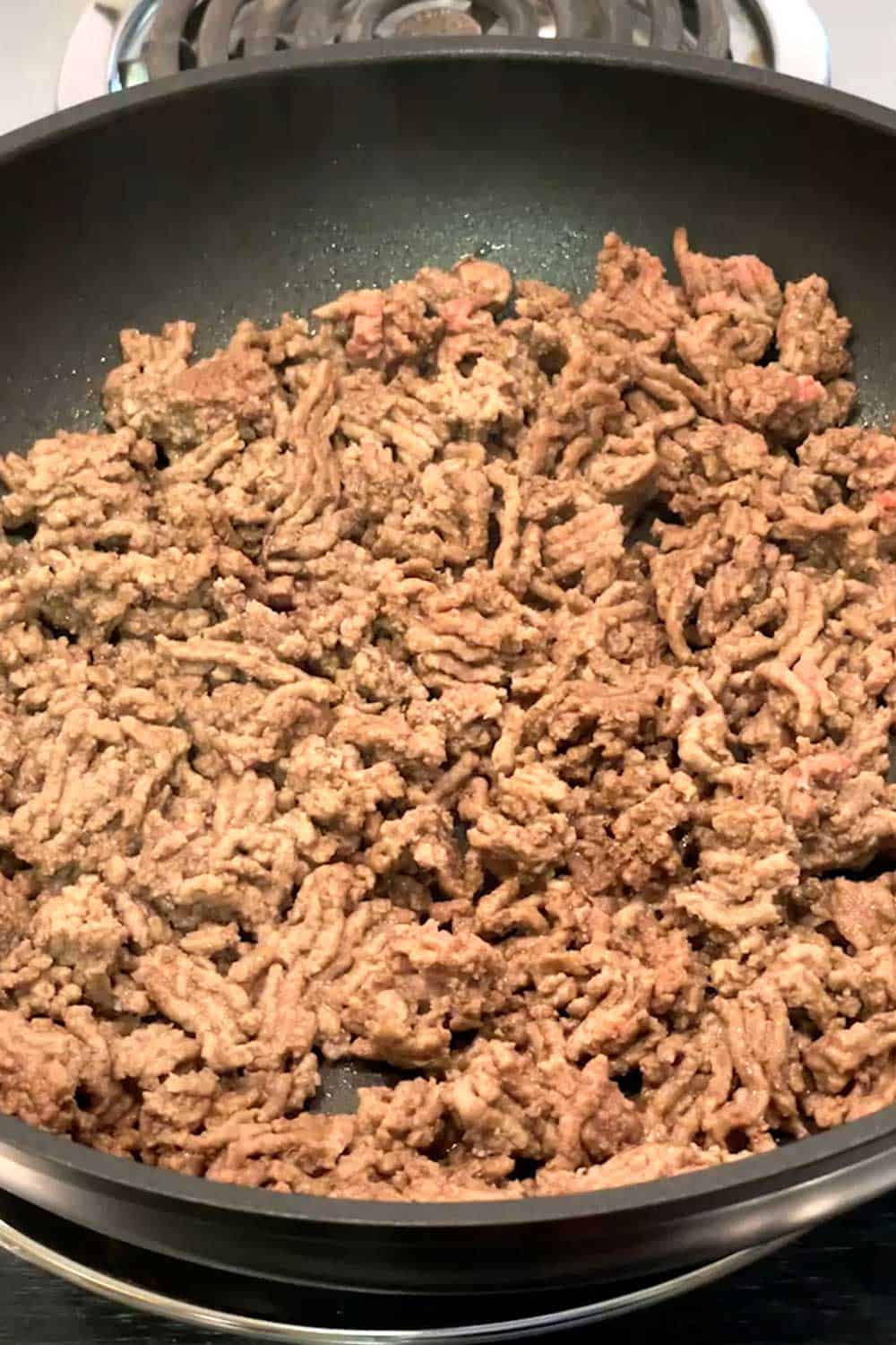 Cooking ground beef in skillet.