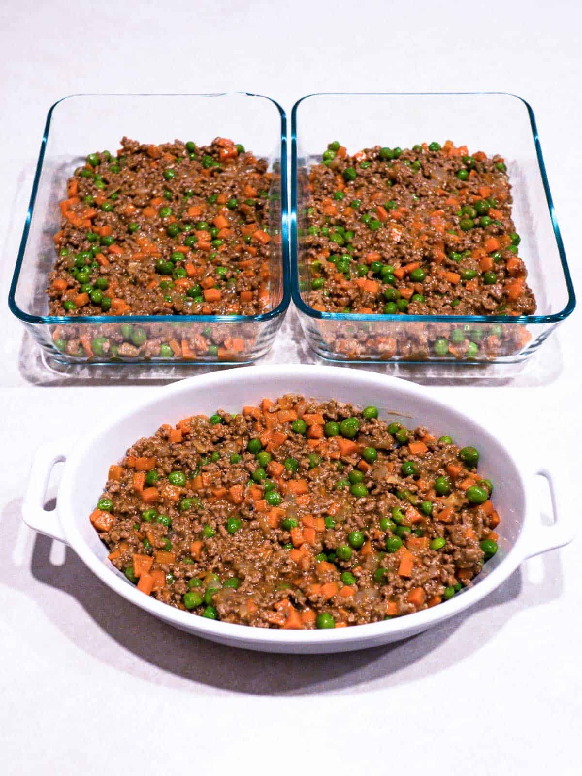 Meat mixture divided among three baking dishes.
