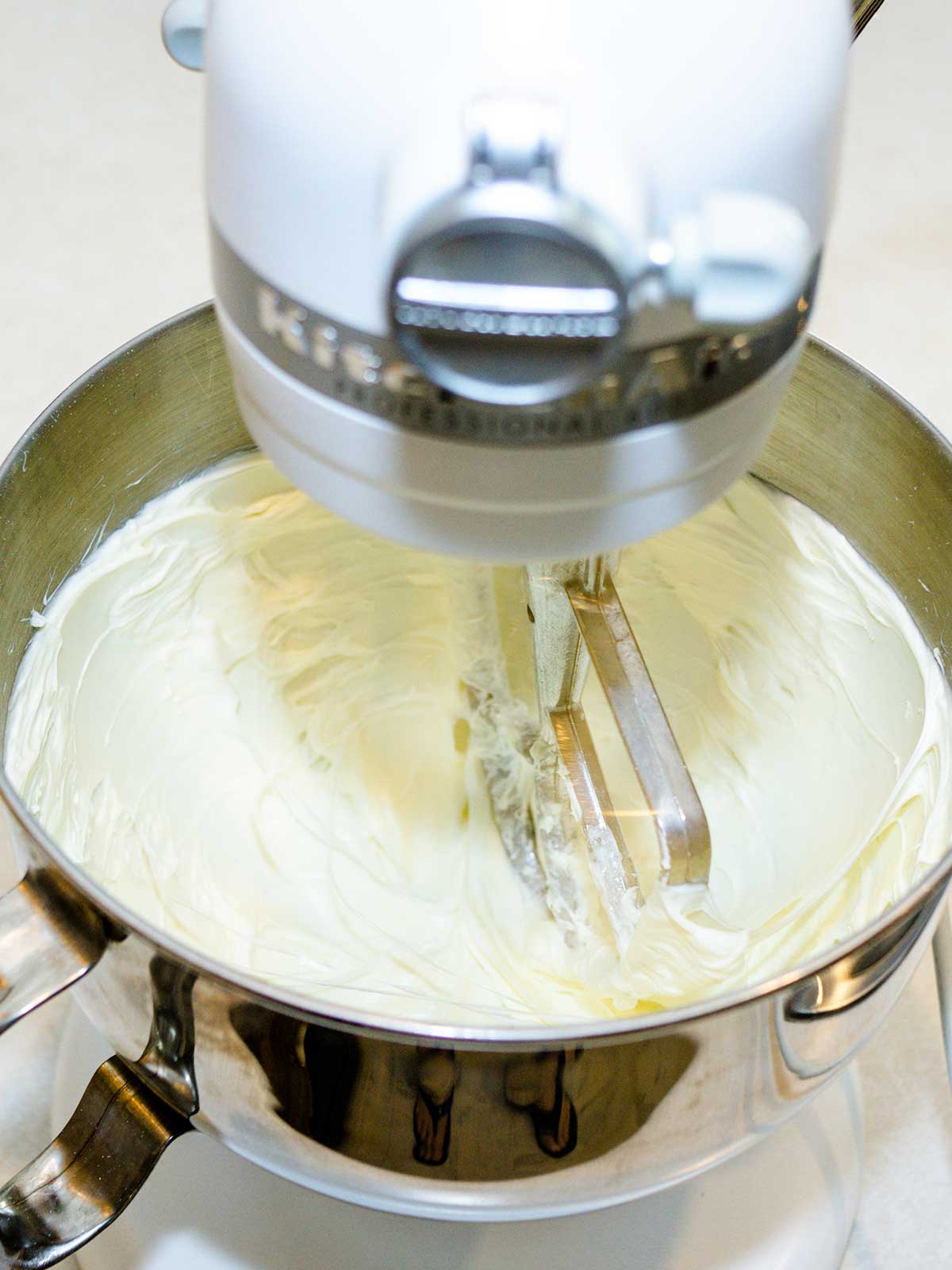 Beating cream cheese in stand mixer.