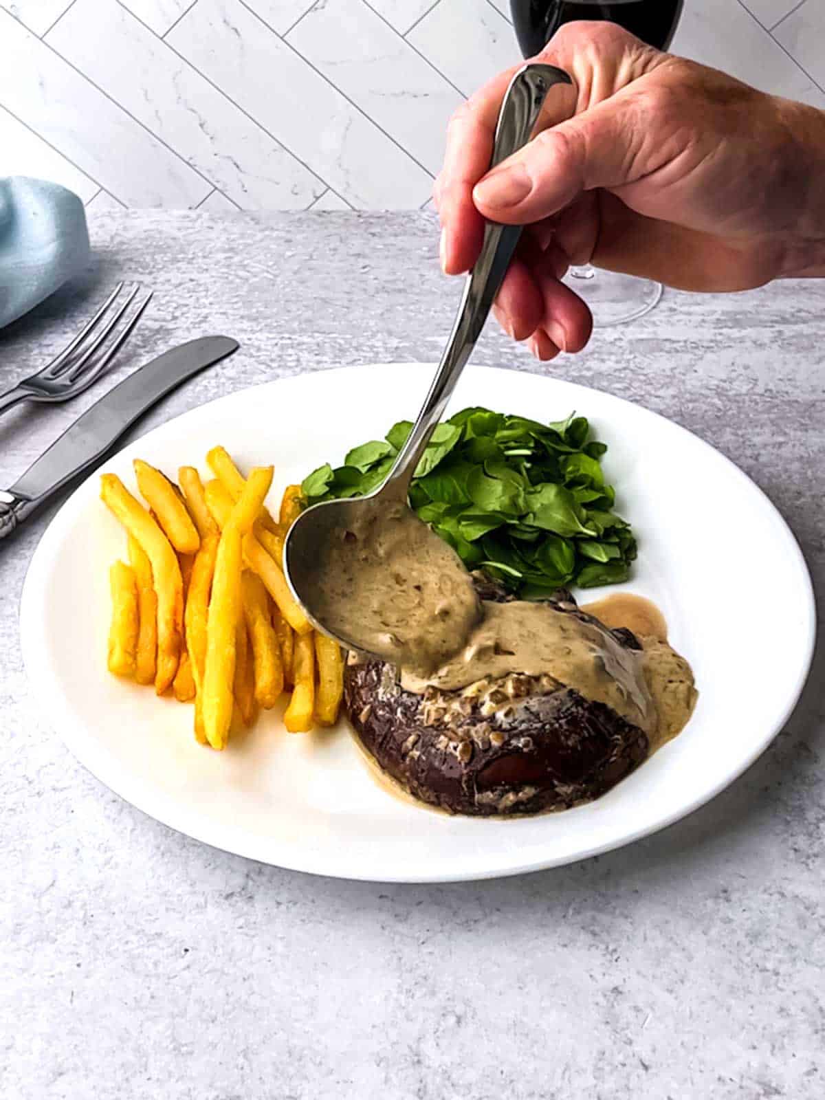 Quick and Easy Portobello au Poivre served with fries and watercress.
