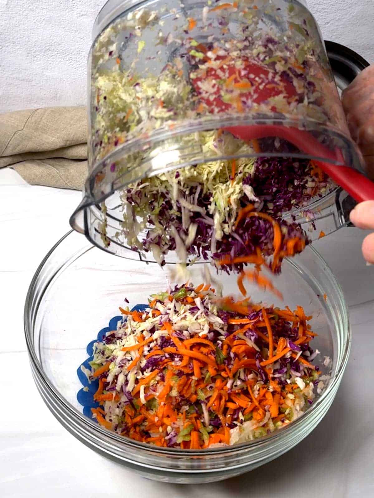 Transferring shredded veggies to a bowl.