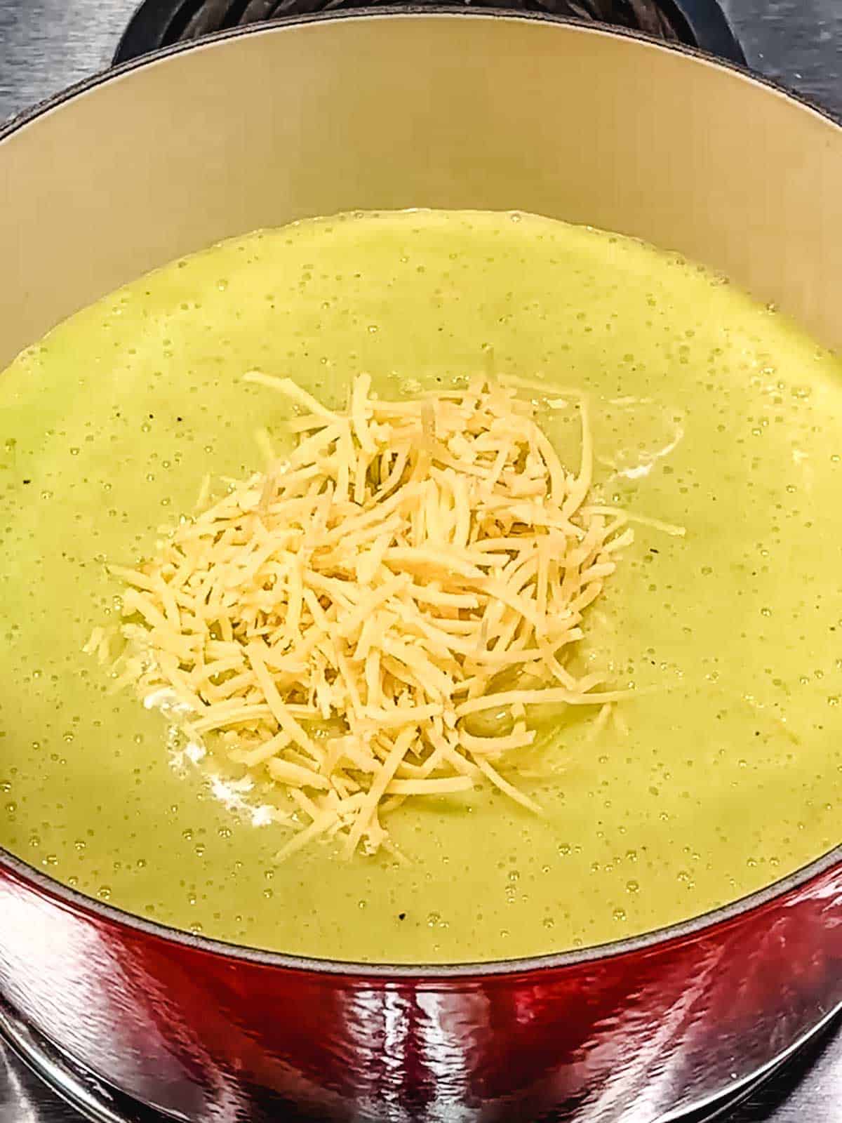 Adding cheese to soup.