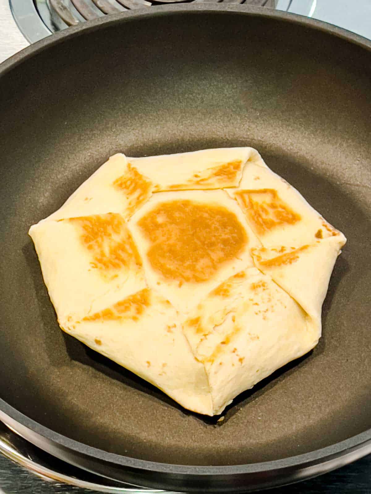 Browned quesadilla in skiller.