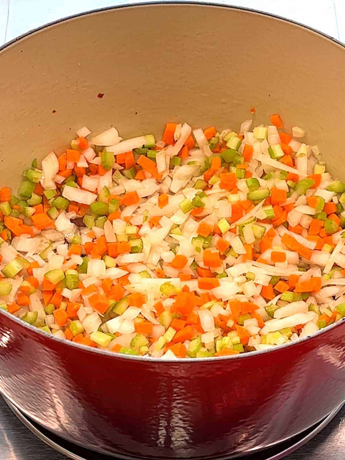 Onions, carrots and celery in Dutch oven.