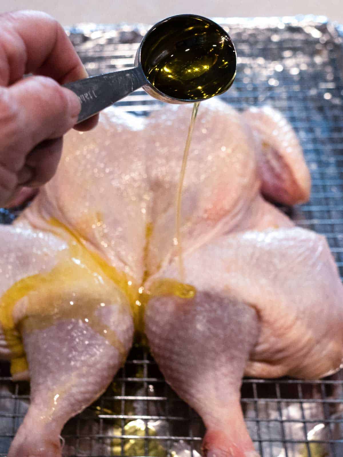 Adding olive oil to the chicken before baking it.
