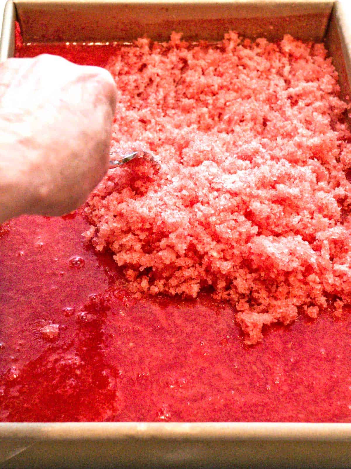 Scraping watermelon granita with a fork.
