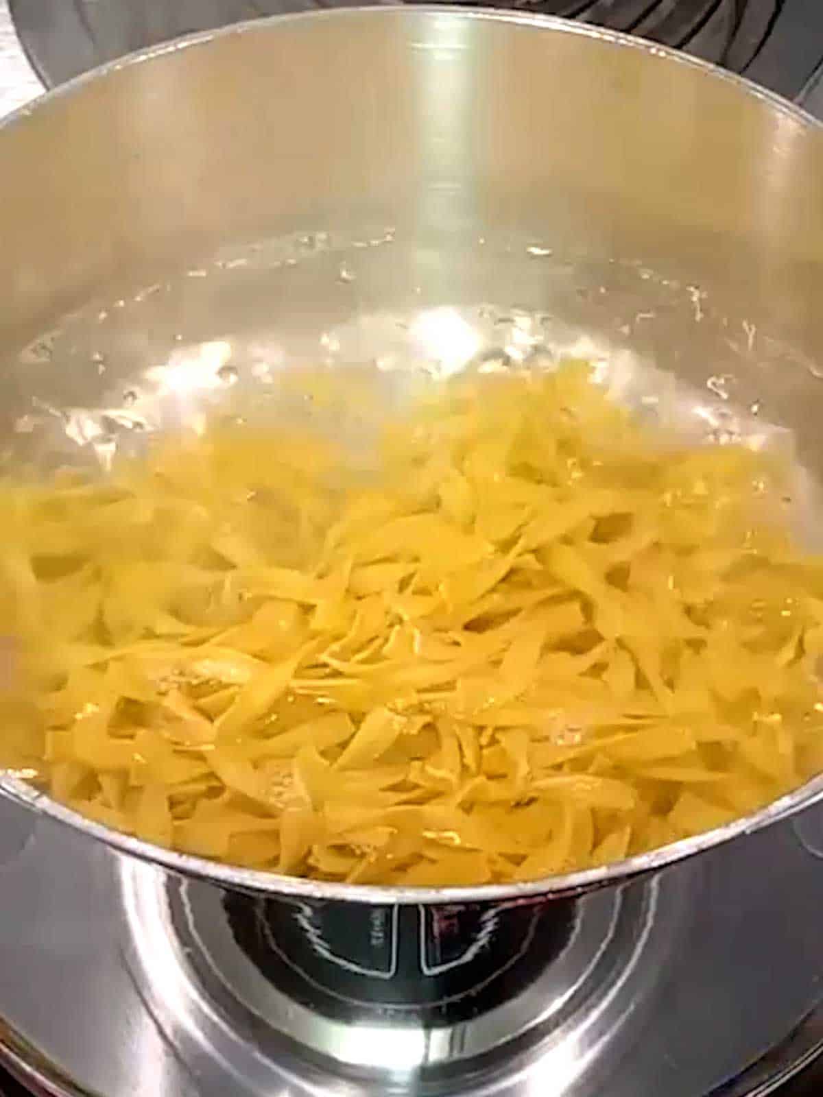 Cooking noodles in boiling water.