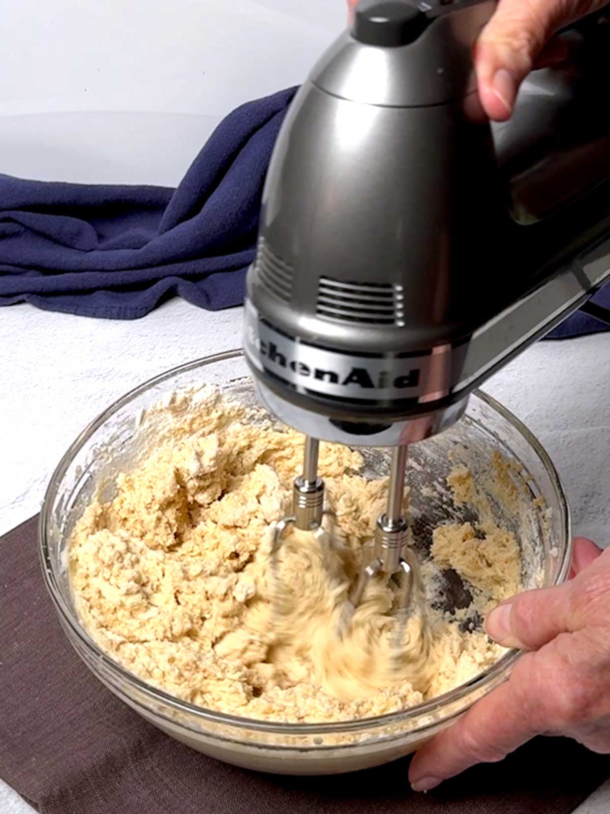 Beating the flour into the cookie dough.