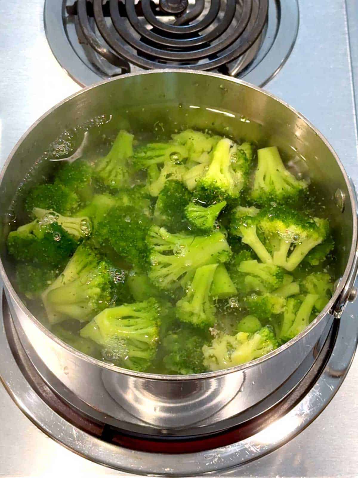 Cooking the broccoli in salted water.