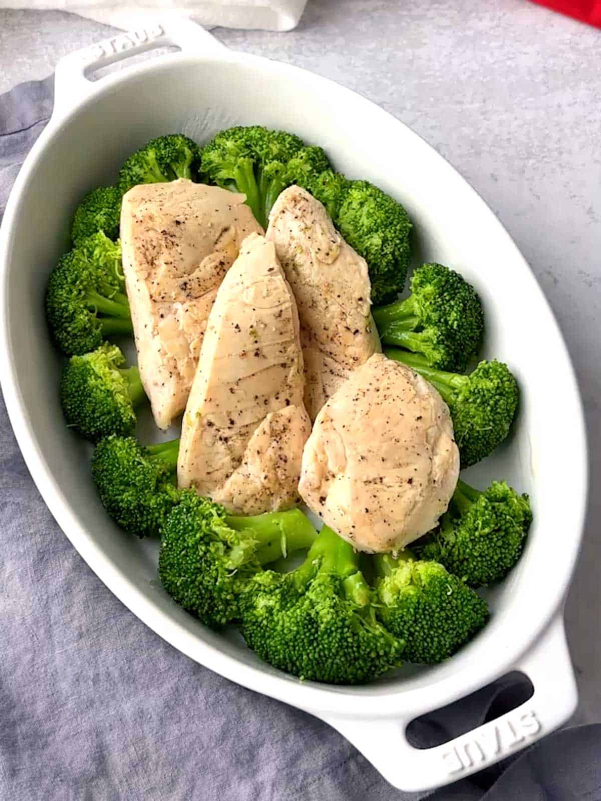 Chicken added to the broccoli in the casserole dish.