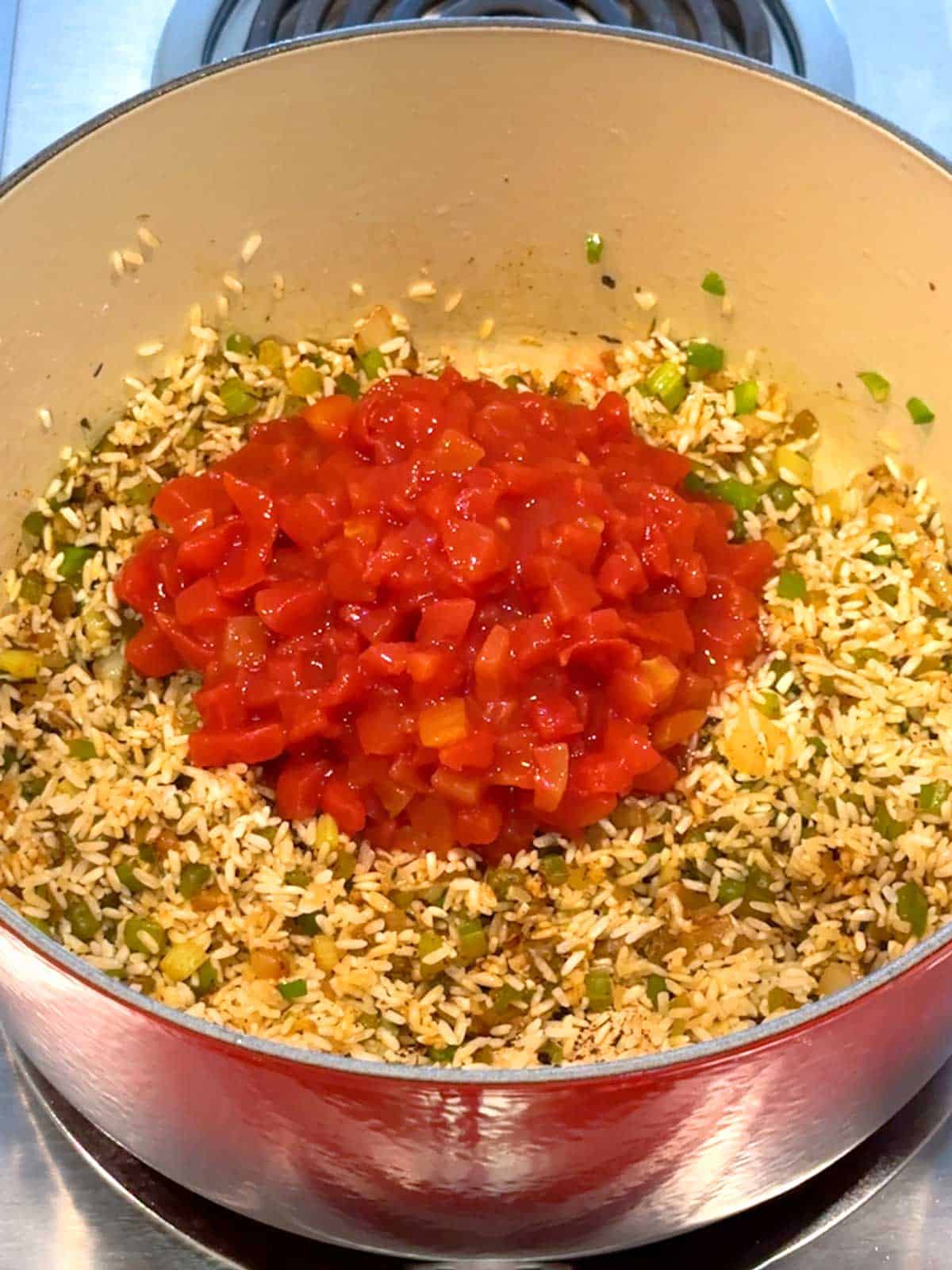 Petit diced tomatoes added to jambalaya mixture.