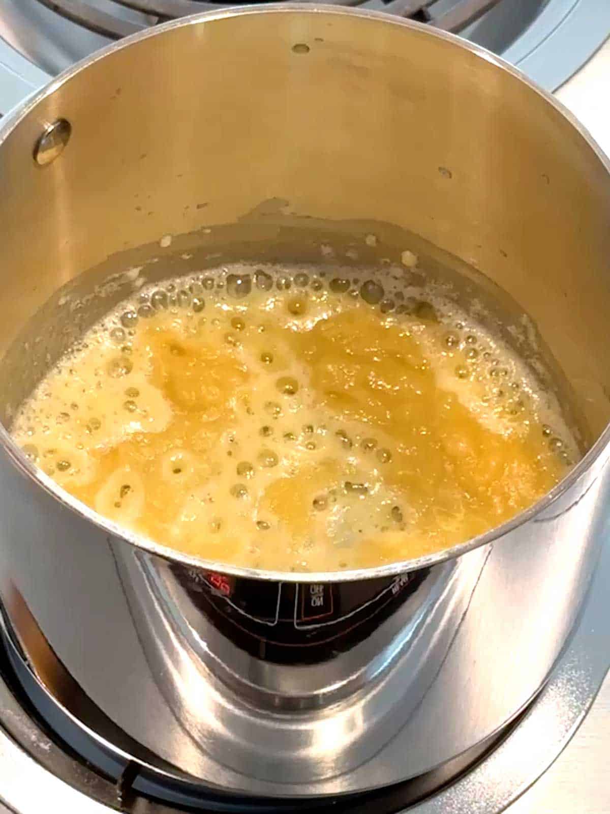 Cooking flour and melted butter together to form a roux.