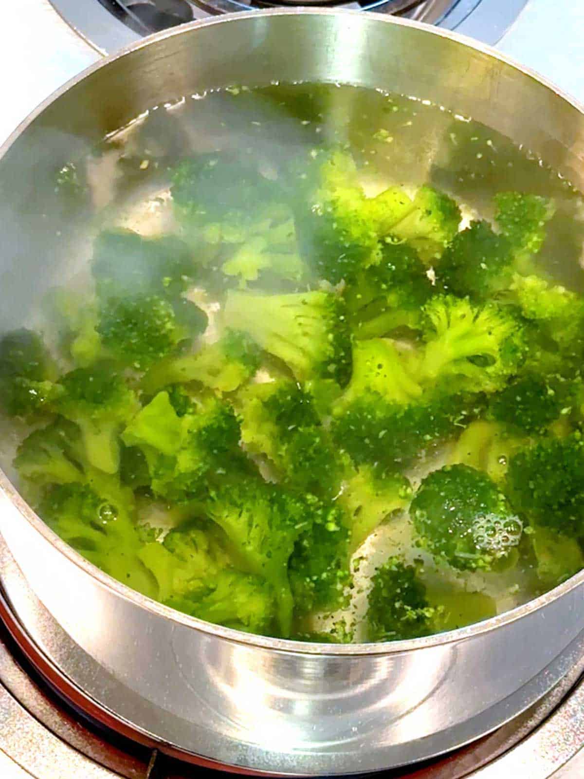 Cooking the broccoli in salted boiling water.