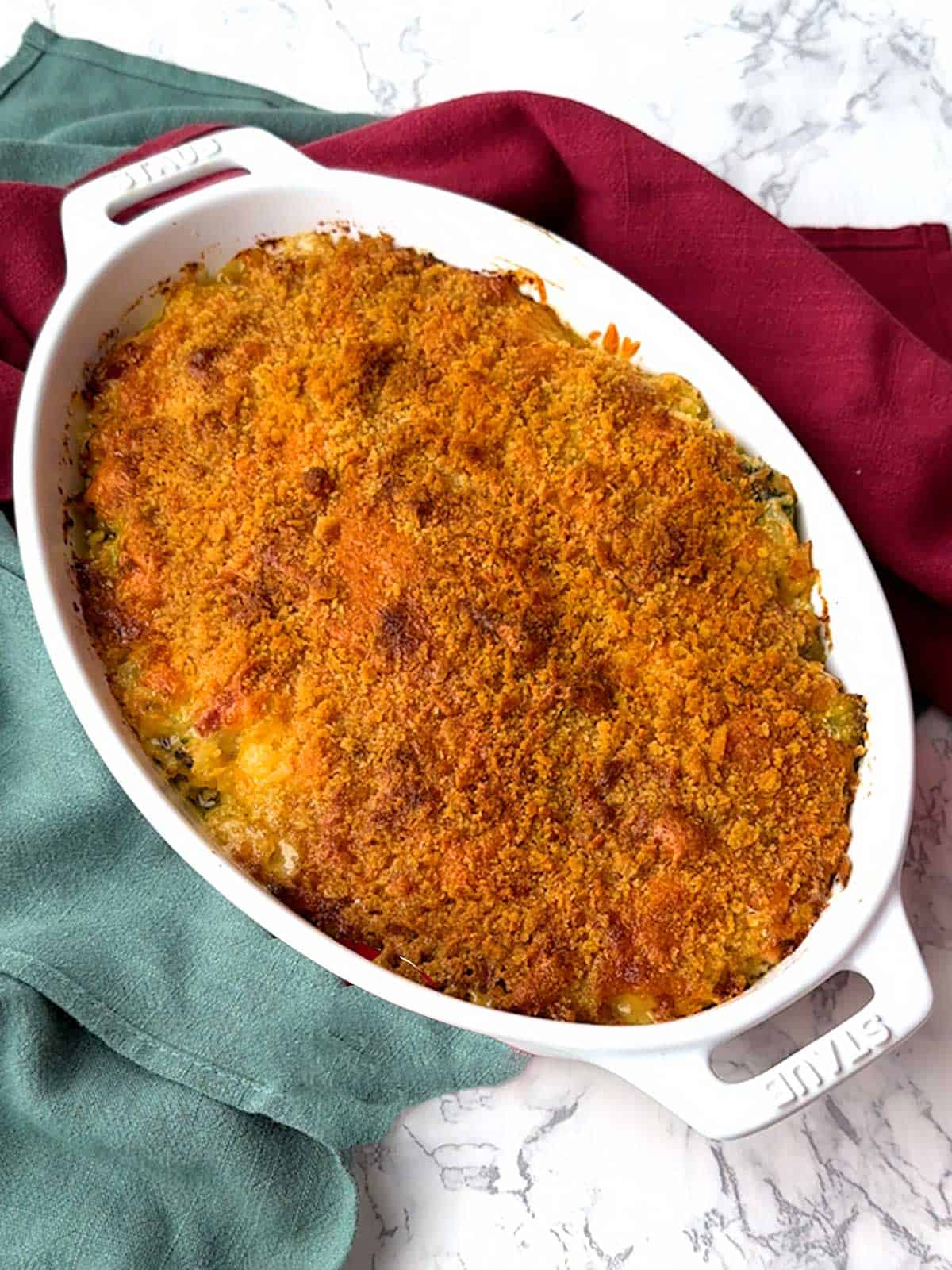 Broccoli ham and rice casserole topped with cheddar cheese and ritz cracker crumbs.