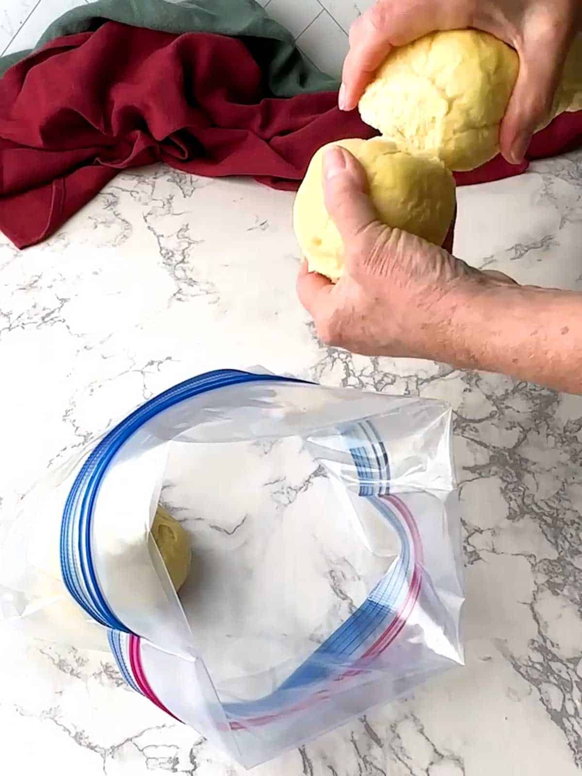Placing parbaked rolls into a Ziploc bag.