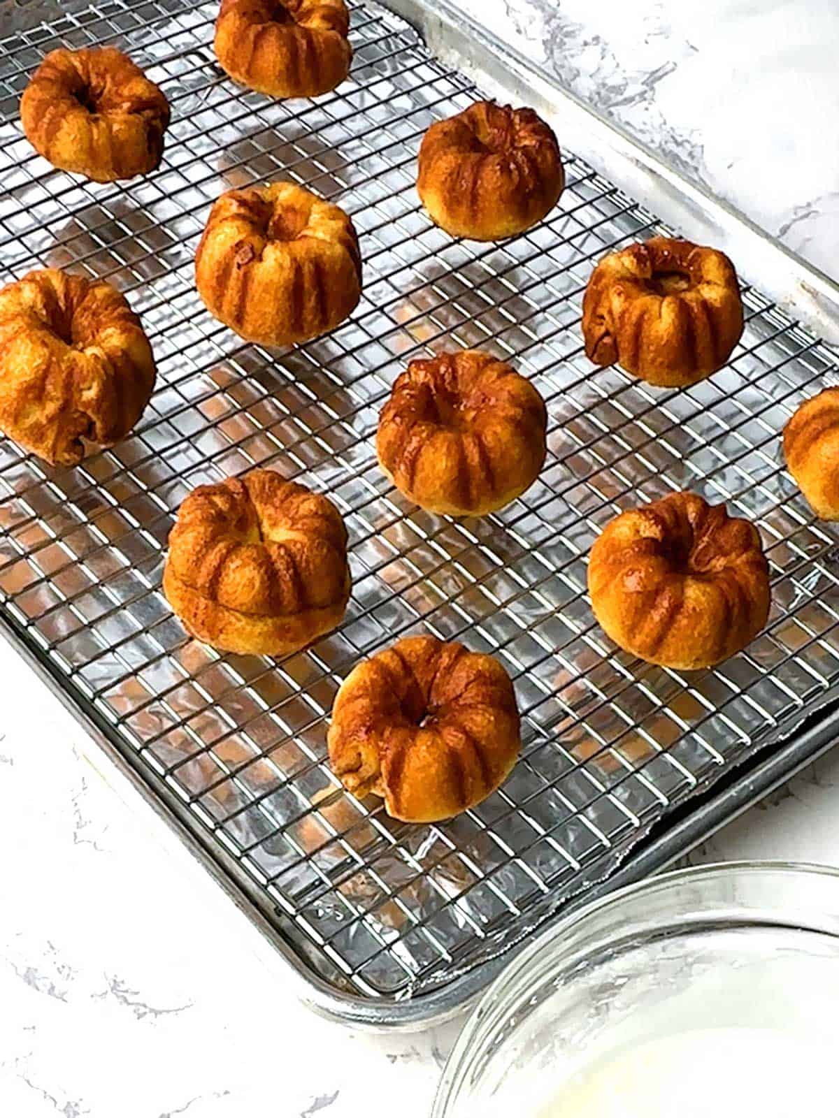 Little cakes cooling on wire rack.