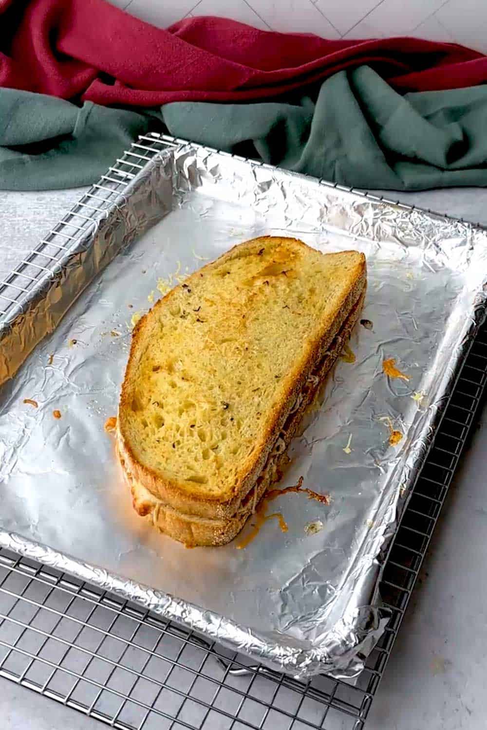 Garlic bread grilled cheese sandwich out of the oven after five minutes.