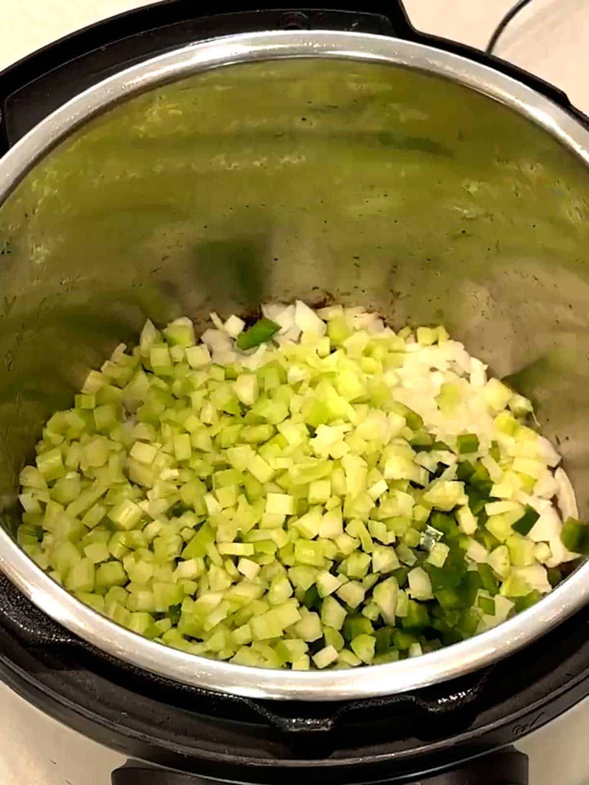 Onions, bell pepper and celery in Instant Pot.
