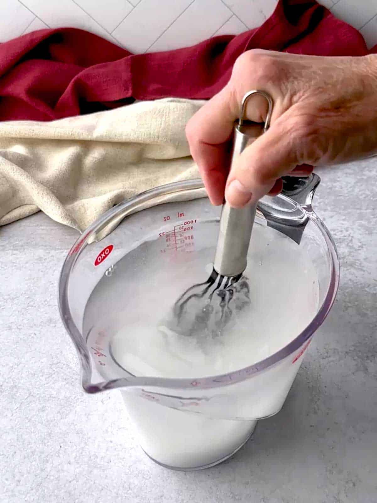 Whisking brining ingredients together.